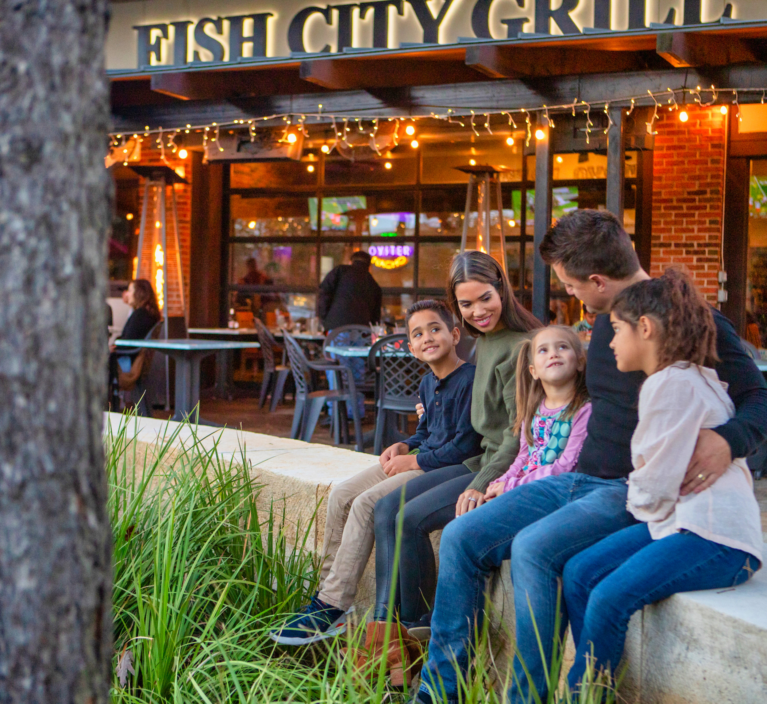Family sitting outside of Fish City Grill