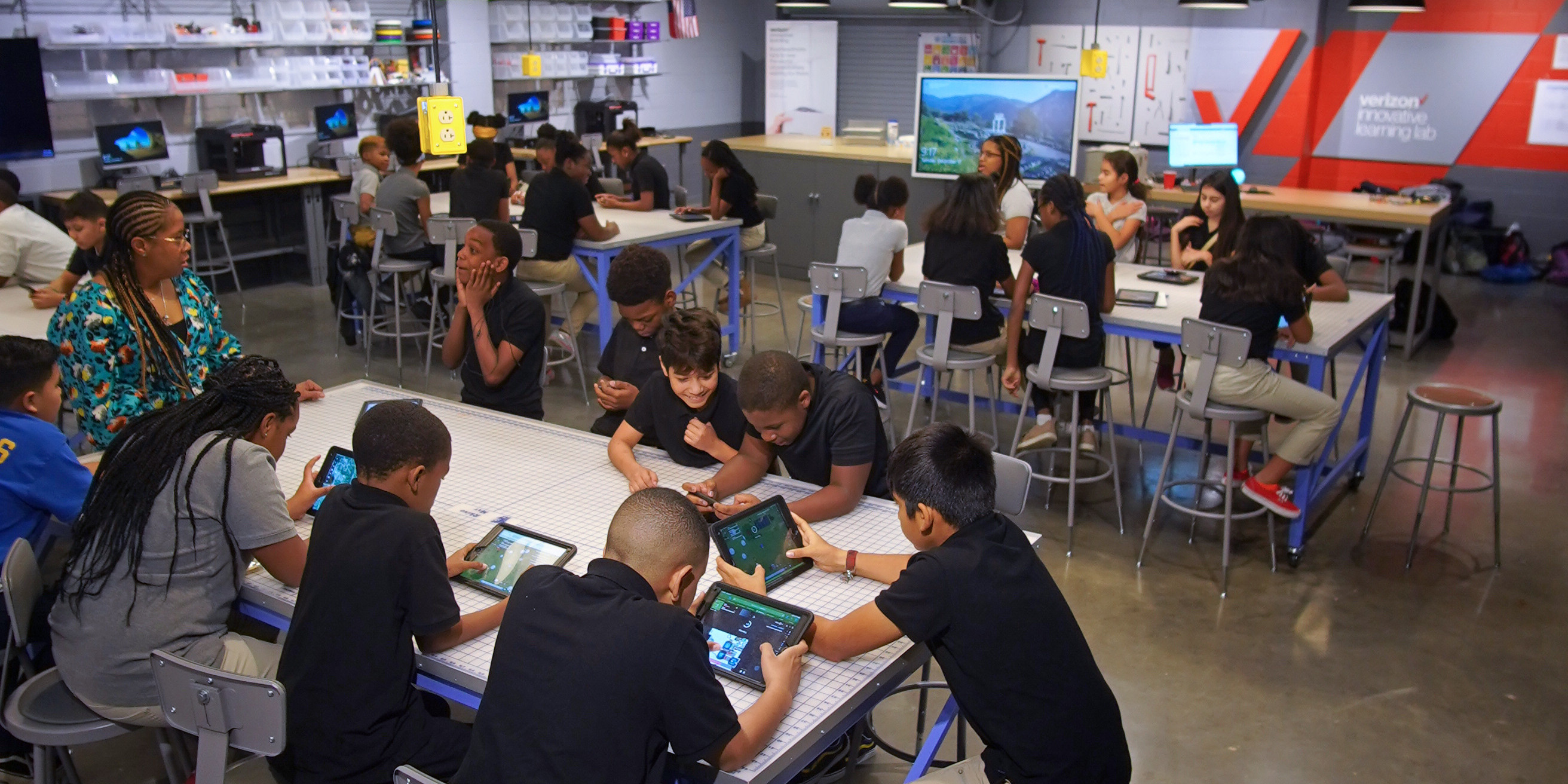Students working on their tablets together at a table