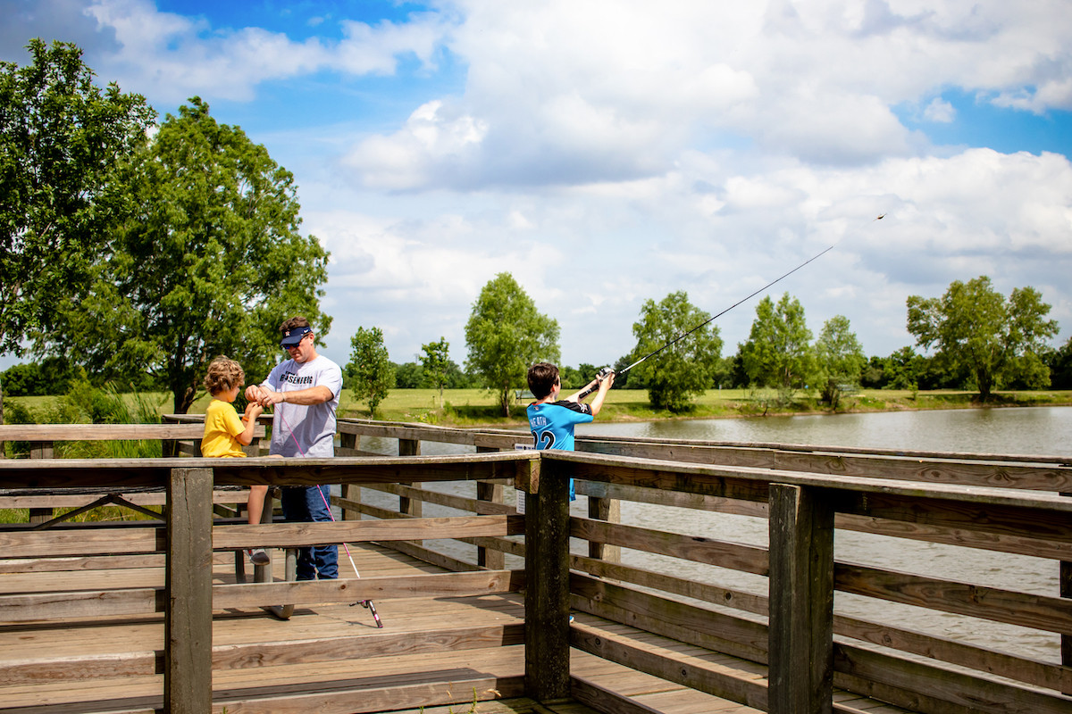 A family fishing off of a dock at Seabourne Creek